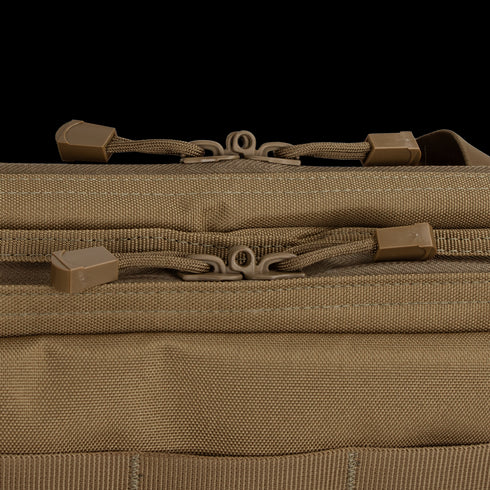 Close-up of two brown zipper pulls on a tan Condor 36 Single Rifle Case, highlighting stitching and textured fabric—ideal for first responders or military use.